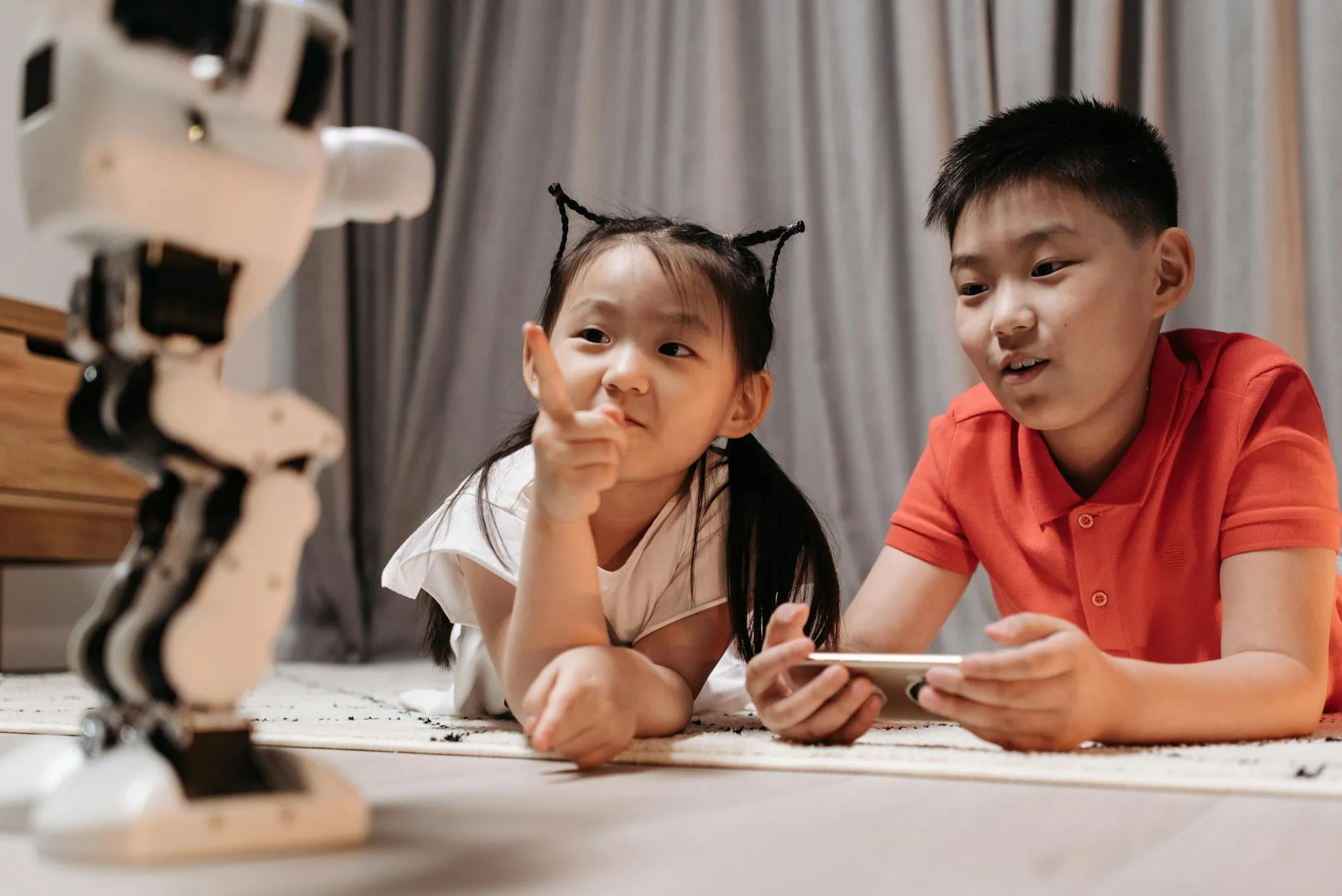 a girl pointing at a robot
