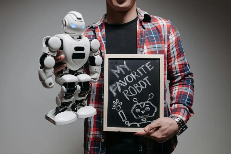 a person wearing plaid long sleeves holding a wooden board and robot