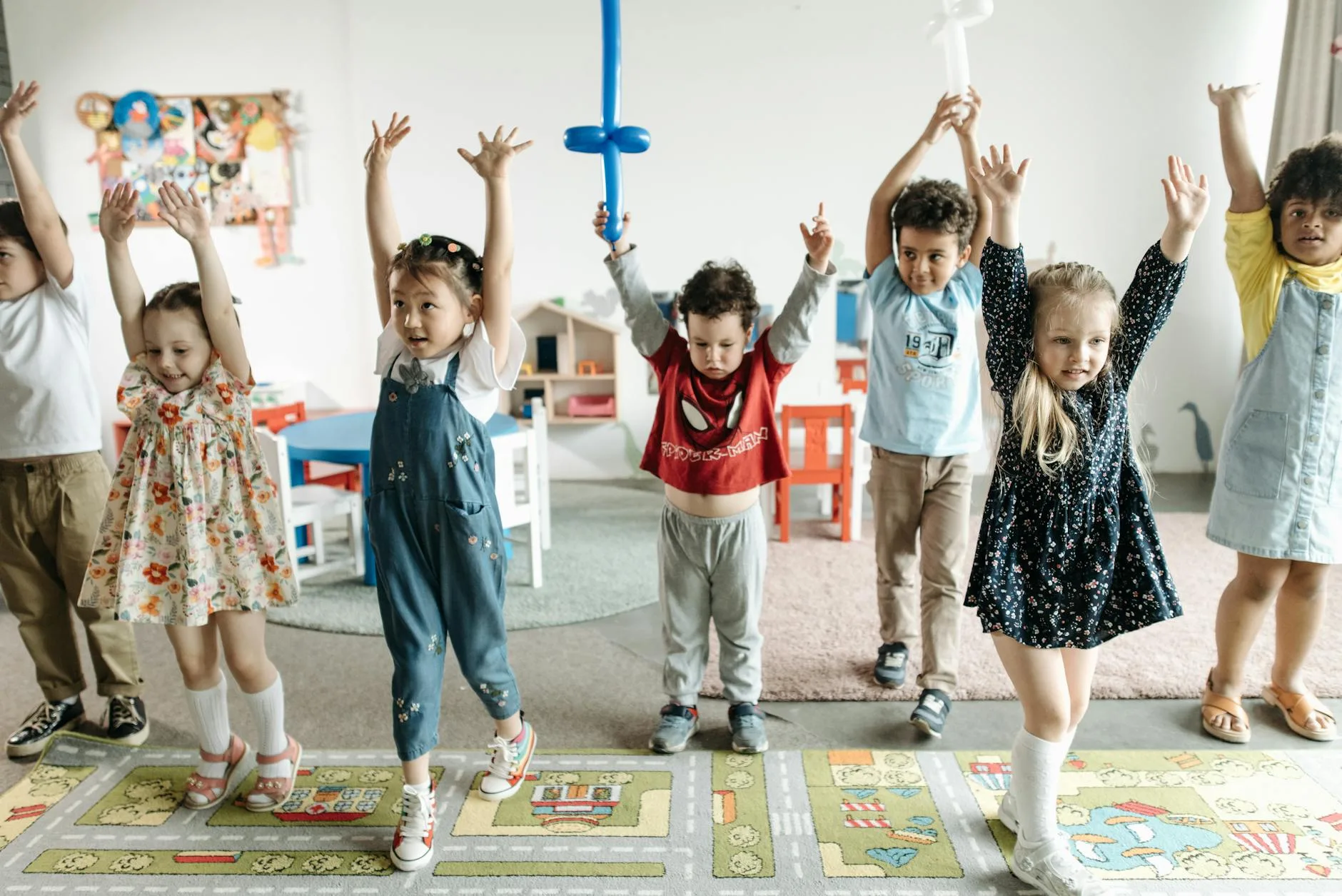 children raising their hands