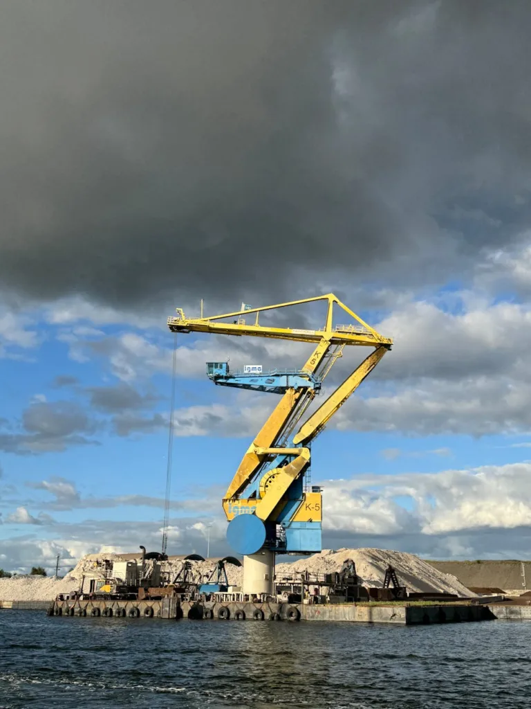 industrial crane at amsterdam port under dramatic sky